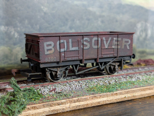 Model railway wagon with 'Bolsover' branding on a track with a scenic background